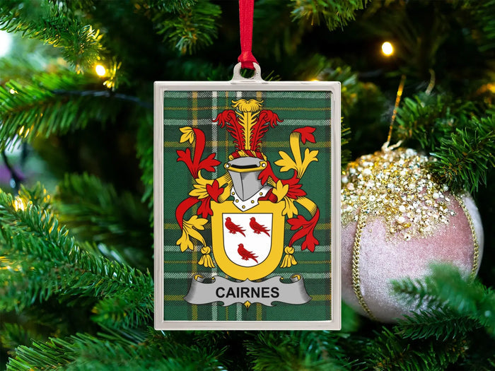 Cairnes Irish family crest Christmas ornament — crest on the Irish national tartan in a silver-tone frame