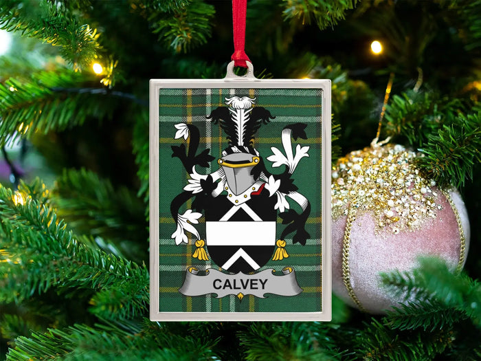 Calvey Irish family crest Christmas ornament — crest on the Irish national tartan in a silver-tone frame