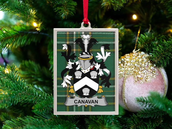 Canavan Irish family crest Christmas ornament — crest on the Irish national tartan in a silver-tone frame