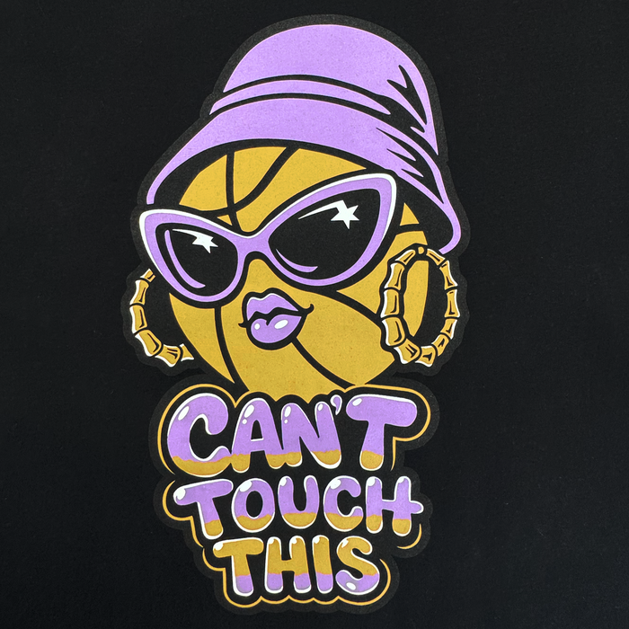 The Can't Touch This Tee by GSV features a stylized basketball with pink lips, sunglasses, a purple hat, and hoop earrings. “CAN’T TOUCH THIS” pops in purple and yellow on black 100% cotton—perfect for Golden State Valkyries fans.