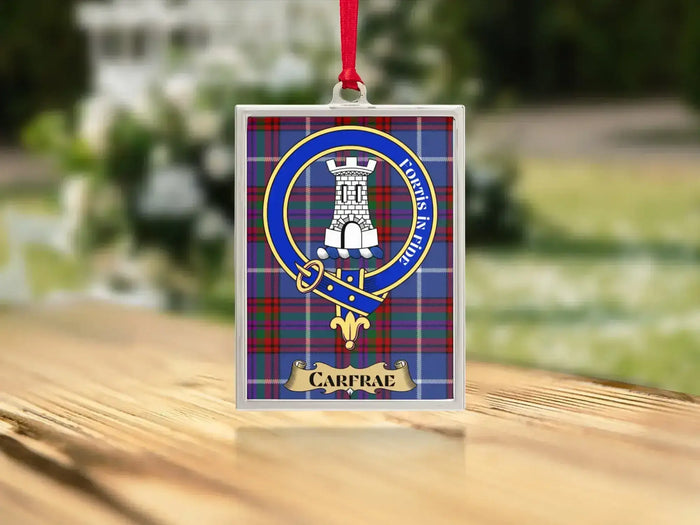 Close-up of the Carfrae family crest on a polished silver-frame metal ornament