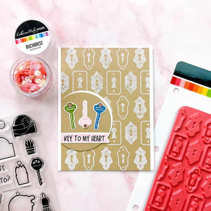 Catherine Pooler - Background Stamp - Lots of Locks. Create a vintage lock background with the Lots of Locks Background Stamp! This repeating pattern will make a great layer for your card inked up in a variety of colors. Available at Embellish Away located in Bowmanville Ontario Canada. Example by brand ambassador.