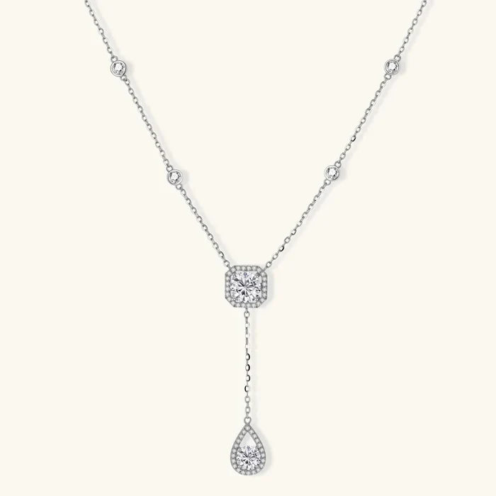 Celestial Balance Necklace in polished silver with bezel-set clear stones, a square halo centrepiece and teardrop drop