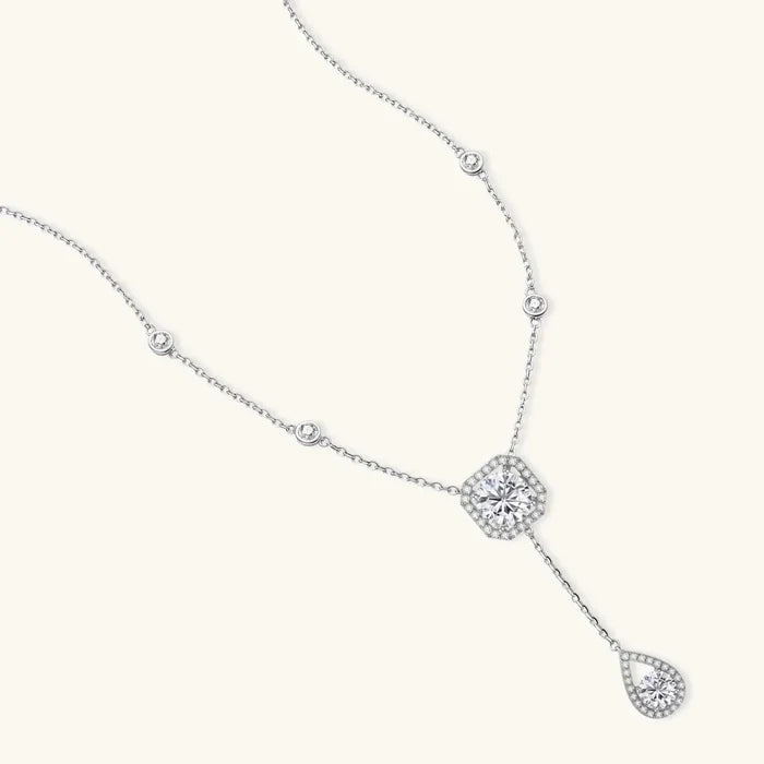 Celestial Balance Necklace in polished silver with a fine chain, bezel-set round stones, halo centrepiece and teardrop drop