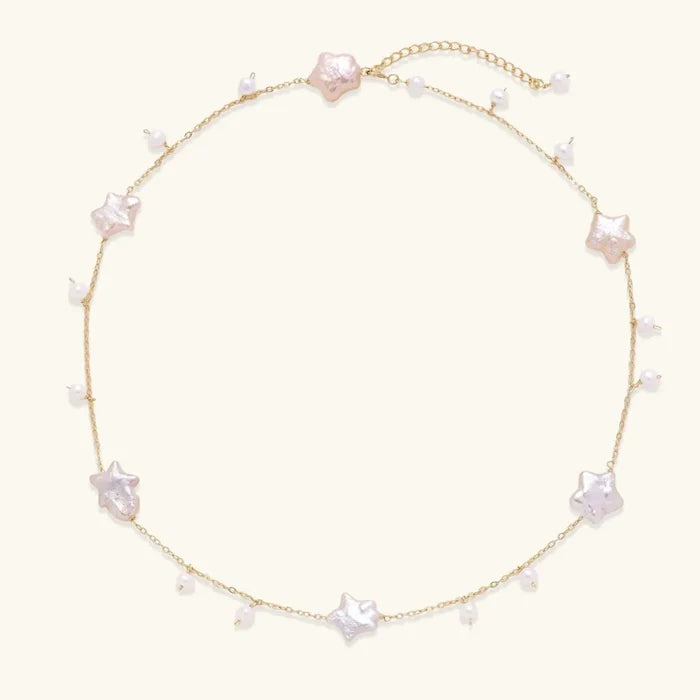 Celestial Pearl Stars Necklace in gold-tone chain with pink-cream star-shaped pearls and small round pearl drops