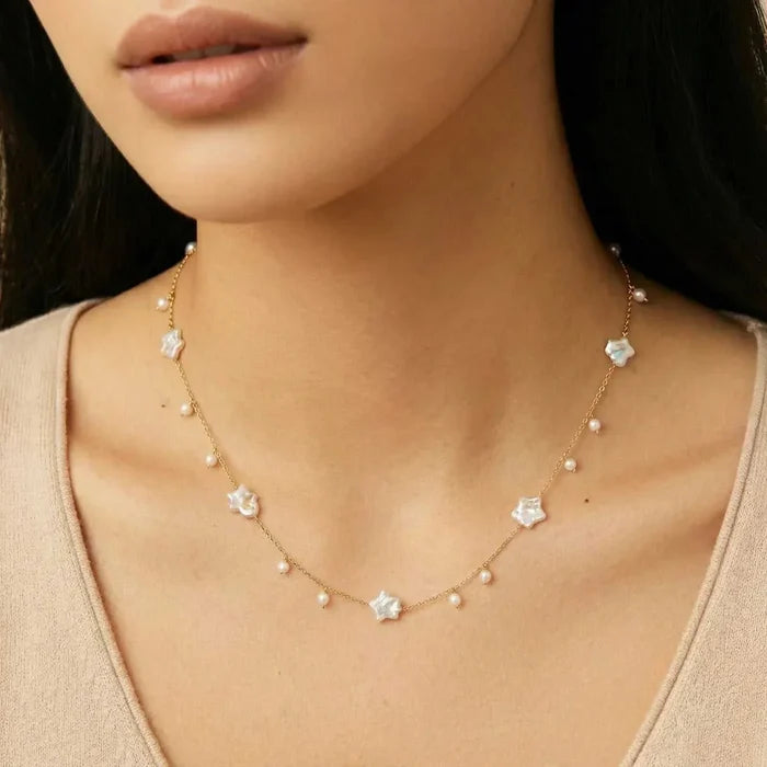 Celestial Pearl Stars Necklace with a delicate gold-tone chain, white star-shaped baroque pearls and small round pearl drops