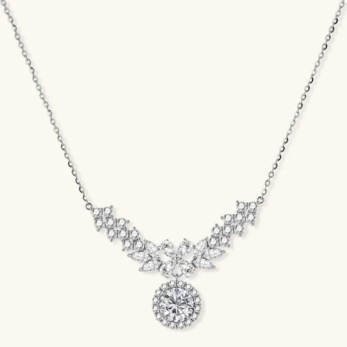 Celestial Wings Statement Necklace in silver-tone metal with clear stones, featuring a symmetrical wing-shaped cluster and round halo drop