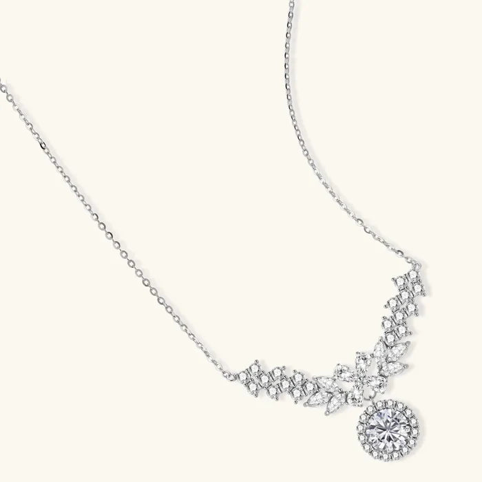 Celestial Wings Statement Necklace in polished silver with clear clustered stones, an ornate wing-like centerpiece and halo drop