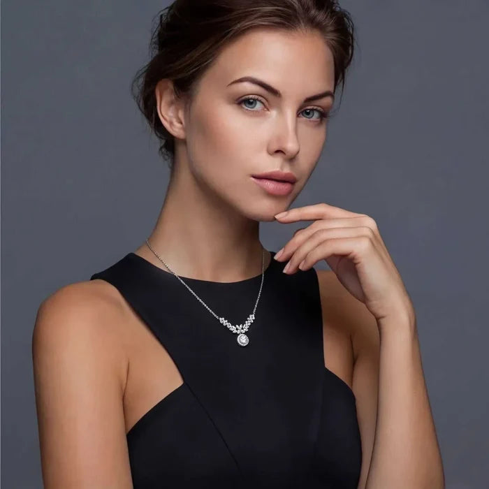 Celestial Wings Statement Necklace in silver with a delicate V-shaped chain, sparkling clustered stones and round pendant