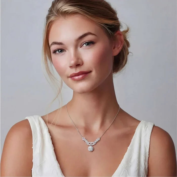 Celestial Wings Statement Necklace in silver-tone metal, featuring sparkling clustered stones and a round halo drop pendant