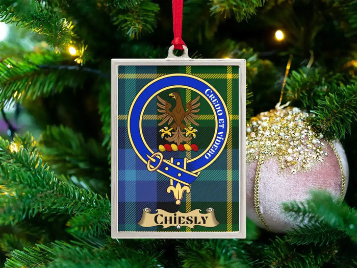 Chiesly clan crest Christmas ornament in a silver frame on a tartan background
