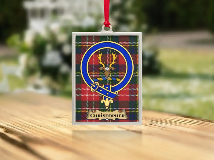 Close-up of the Christopher family crest on a polished silver-frame metal ornament