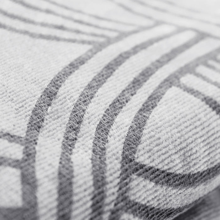 A close-up image of the Classic Logo Beach Towel by Oaklandish features a pattern with intersecting geometric lines. Made from 100% ringspun cotton, the super soft fabric appears textured, with visible fibers creating a slightly raised surface. The lines are gray against a lighter gray background, giving a monochromatic look.