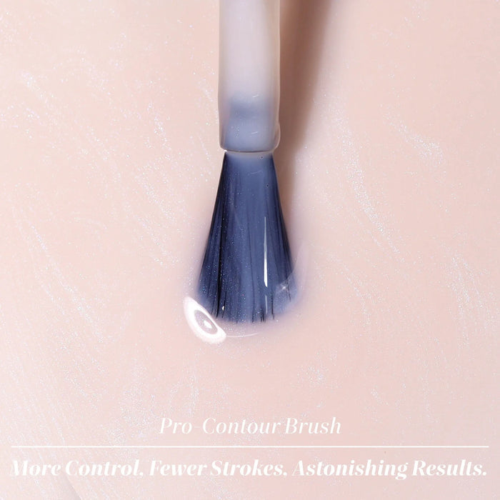 A LONDONTOWN Conceal + Go Pink makeup brush with a clear handle lies on a smooth, light pink surface. Text below reads: "Conceal + Go Pink. More Control. Fewer Strokes. Astonishing Results.