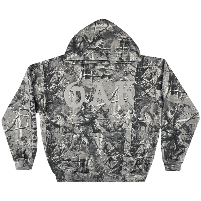 The Oaklandish Cork Hoodie is a men’s pullover in grey wood camo, inspired by tree and branch patterns. "OAK" appears in bold white letters across the upper back, centered between the shoulders.