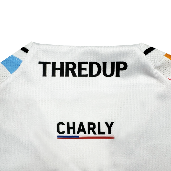 Close-up of the back of a white Oakland Roots SC Custom Unisex Mosaic in Motion Kit showing "THREDUP" in bold black near the collar, "CHARLY" below it, and a small blue-white-red tricolor stripe under "CHARLY.