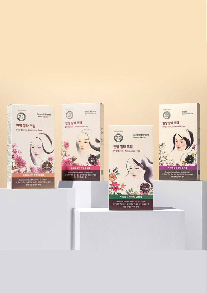 Set of facial mask packages on a white stand with a beige background