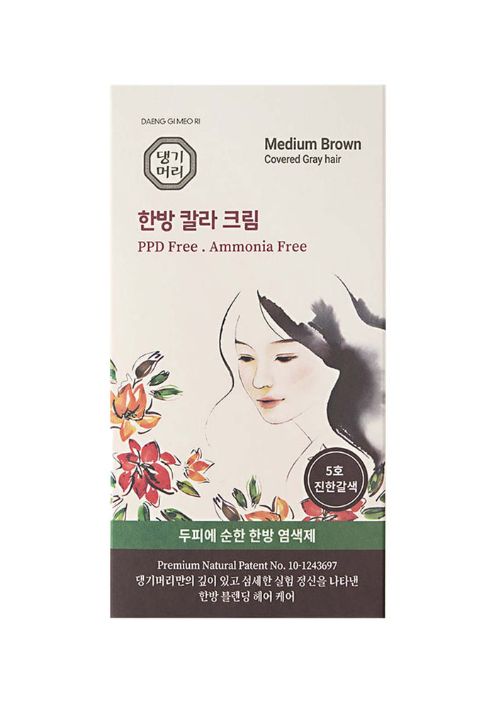 Hair color kit packaging with a woman's face and floral design on a white background