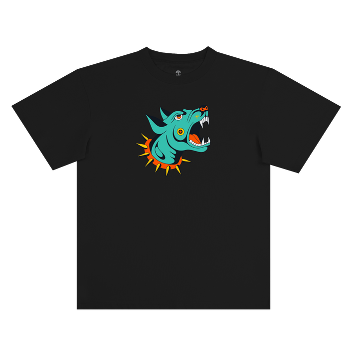 Introducing the Dawg Tee by Other: a black classic fit t-shirt showcasing a bold, cartoon-inspired blue-green snarling wolf head with sharp white fangs, vivid orange eyes, and an orange spiked collar centered on the chest. Crafted from 100% cotton and inspired by tattoo flash art, this standout design pops brilliantly against the dark fabric.