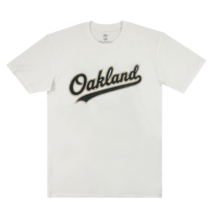 The Oakland Ballers Dugout Tee is a white shirt featuring "Oakland" in bold black script with gold outline and a swooping underline—no other designs—perfect for any fan of Oakland baseball.