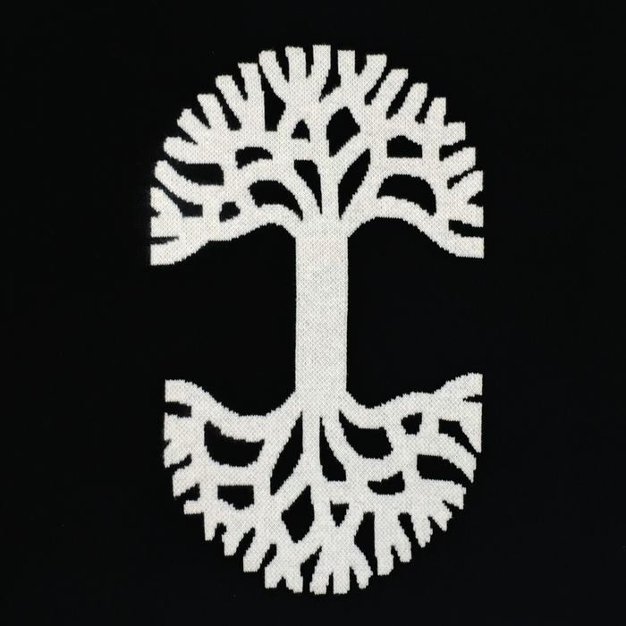 The Oaklandish Ease Jersey features a white stylized tree with large limbs and mirrored roots on a black background, creating a classic, symmetrical design in unisex sizing.
