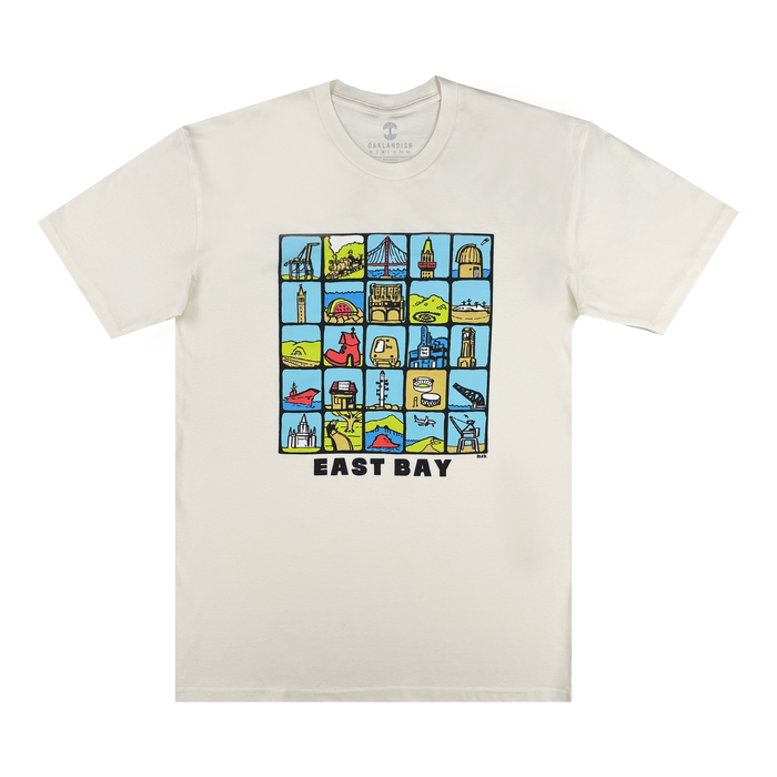 The Oaklandish East Bay Landmarks Tee is a white shirt featuring a grid of colorful, artist-inspired images of local landmarks, nature, animals, and buildings. "EAST BAY" appears in bold black letters beneath the illustrations.