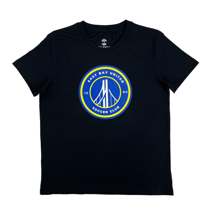 The EBU Women's Tee by Supported Brands is a black t-shirt featuring a circular emblem on the chest. The emblem, with yellow and blue borders, showcases a stylized white bridge illustration in the center. The text around the emblem reads "EAST BAY UNITED SOCCER CLUB" at the top and "1980" at the bottom, celebrating our vibrant youth soccer club.