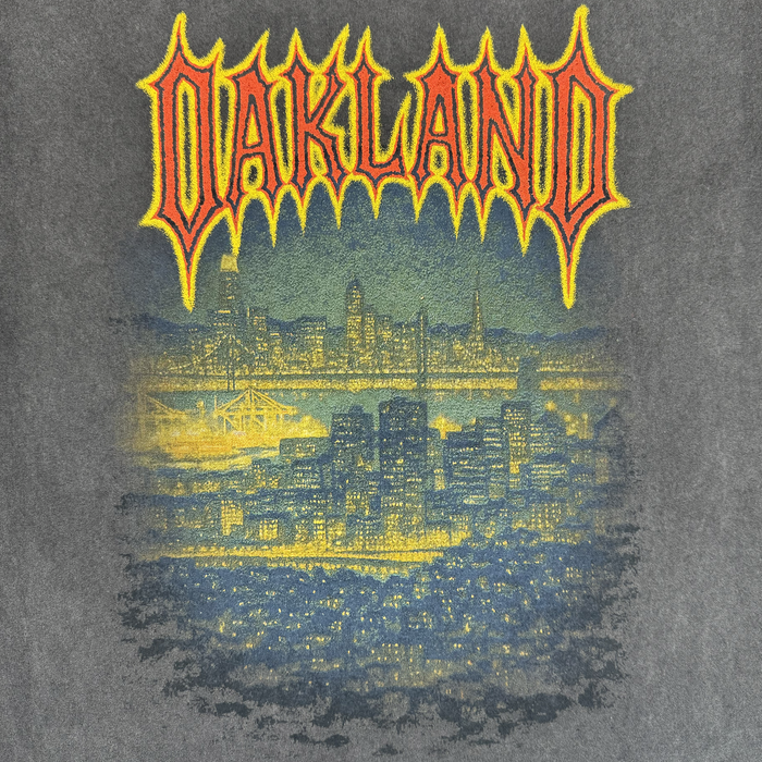 The Ember Tee by Oaklandish is a 100% cotton men’s t-shirt with a gritty, vintage look, showcasing the glowing Oakland skyline at night and "OAKLAND" in bold, jagged letters above the city. Classic fit and perfect for showing hometown pride.