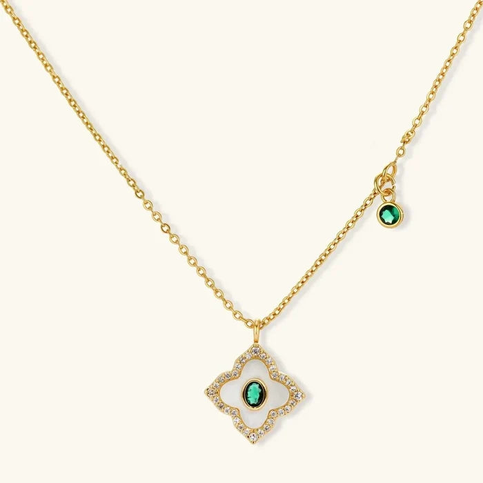 Emerald Bloom Clover Necklace with a gold-tone chain, white inlay clover pendant, pavé accents and green center stone