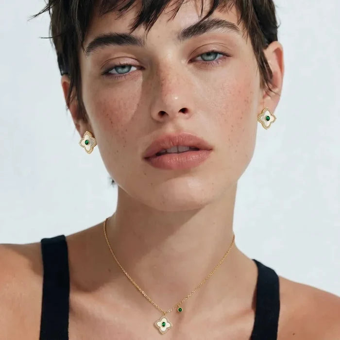 Emerald Bloom Clover Necklace in gold-tone metal with mother-of-pearl clover pendant, green center stone and matching earrings