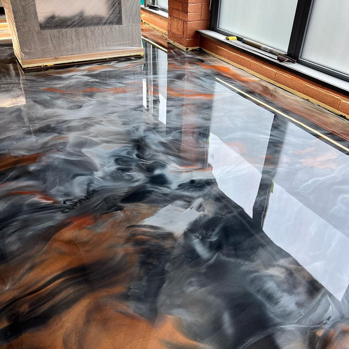 Orange and black metallic epoxy floor. Clear epoxy coatings that are great as a garage floor epoxy kit, clear epoxy coating, and an epoxy floor kit. epoxy coating for floor & epoxy garage floor kit. epoxy for garage floors
