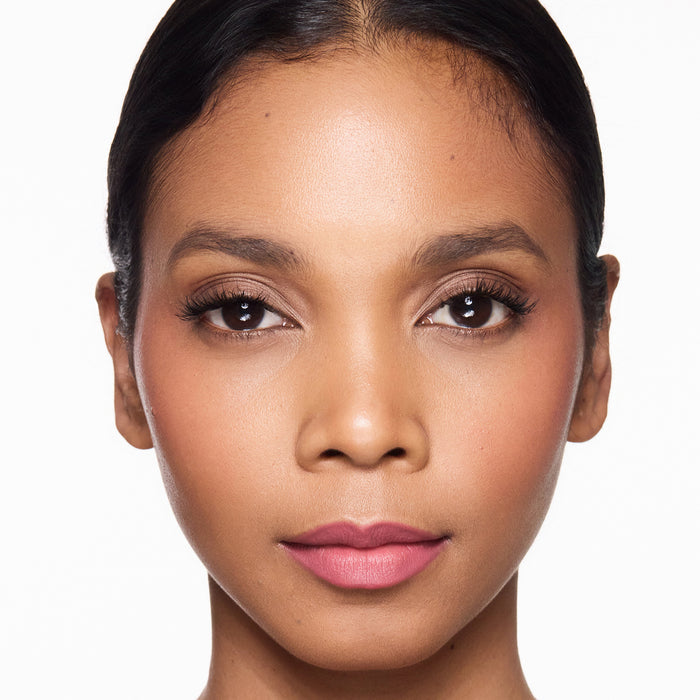 Close-up of a woman's face with a neutral background