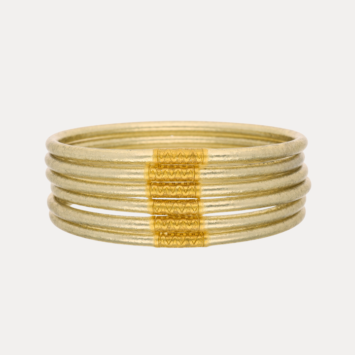 a stack of gold bracelets