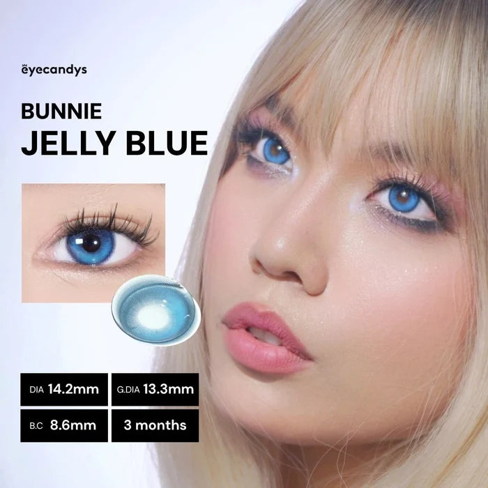 Full face of model wearing EyeCandys Bunnie Jelly Blue colored contact lenses. Close-up highlighting translucent aqua iris, luminous glow, long lashes, and soft limbal ring for a fresh, modern eye look.