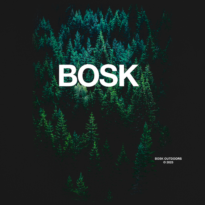 A dense forest of pine trees viewed from above fades into darkness at the edges. Large white text in the center reads “Forest Brush Tee.” Smaller text at the bottom right says, “Other © 2023,” evoking the rugged spirit behind every classic fit t-shirt crafted from premium heavy-weight cotton.