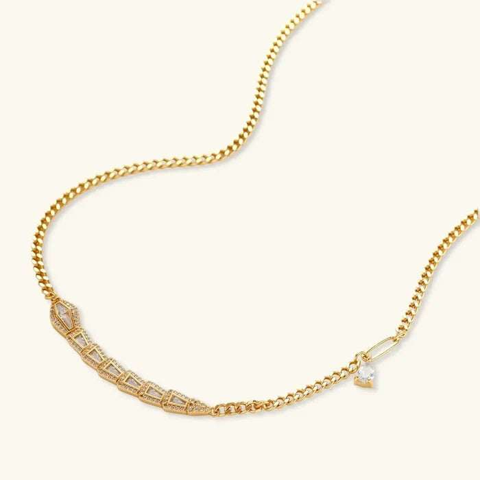 Geometric Luxe Snake Necklace in gold-tone chain with a segmented geometric snake motif and small clear drop accent