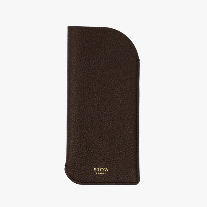 STOW London's Glasses Case in Espresso pebbled leather, featuring a gold logo on a light background