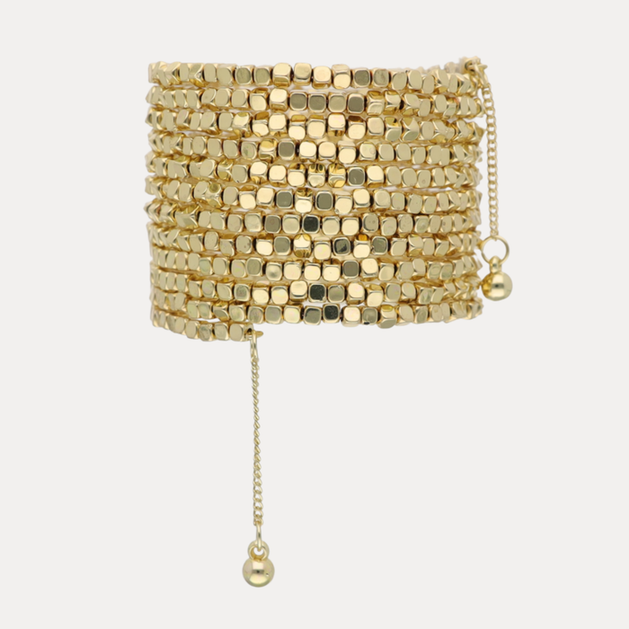 BuDhaGirl Gold Omega wrist wrap with layered cube cut gold beads and adjustable dangling chains creating a sculptural bangle bracelet for women