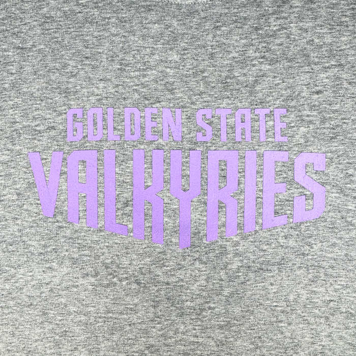 A close-up of the GSV Golden State Valkyries Circle Lock Up Crew, a premium heavyweight gray fleece sweatshirt with bold purple “GOLDEN STATE VALKYRIES” text in a large, stylized geometric design.