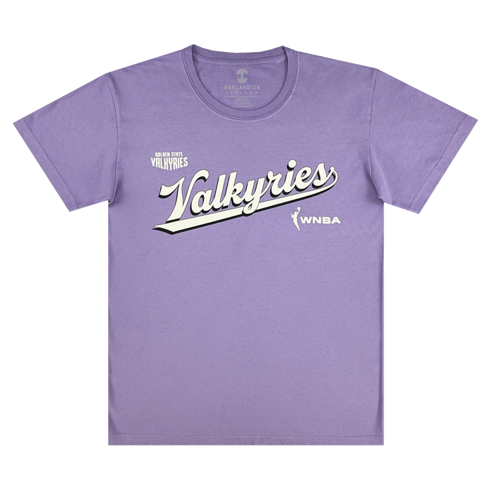 The GSV Golden State Valkyries Retro Script Premium Tee is a light purple, organic cotton heavy tee with "Valkyries" in large white script, "Golden State Valkyries" above, and the WNBA logo and text on the lower right.