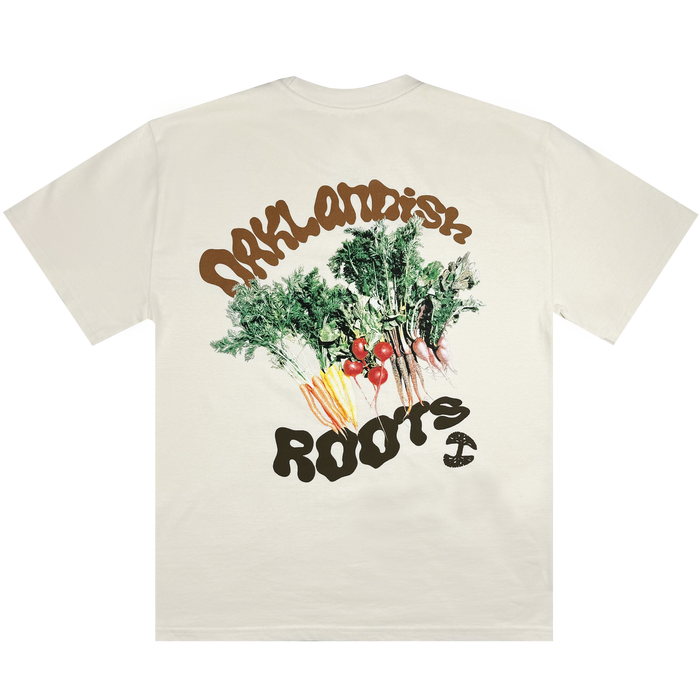 The Grow Your Roots Heavy Tee by Oaklandish is a heavyweight cream t-shirt made of combed cotton, featuring vibrant illustrations of root vegetables like carrots and beets complete with their greens. The word "Arilandish" arches above the artwork, with "Roots" and a turntable needle depicted beneath. Designed in men's sizing for a boxy fit, it combines style and comfort effortlessly.