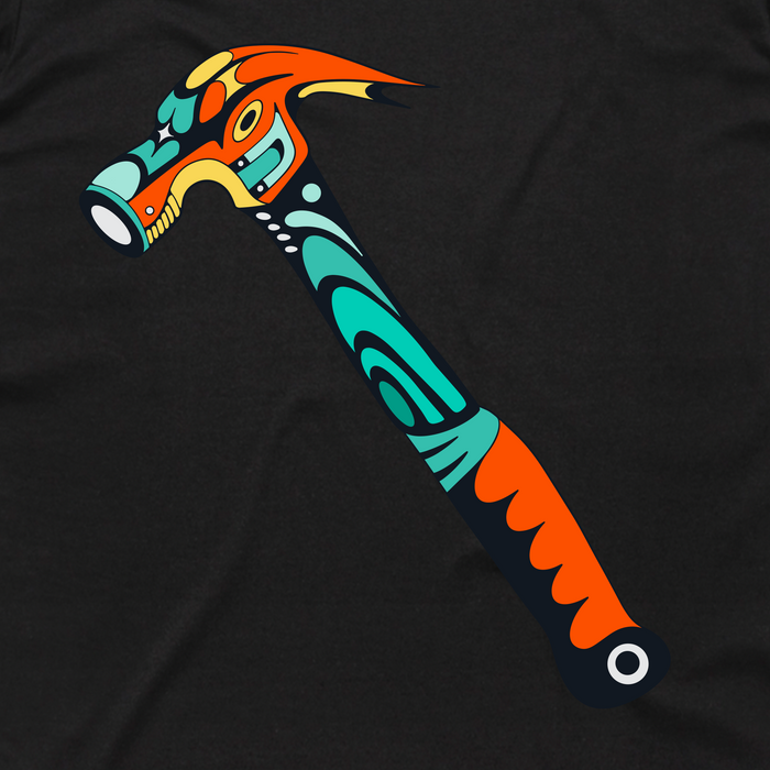 The Hammer into Time Tee by Other features a stylized hammer design inspired by Indigenous art, with bold geometric patterns in turquoise, orange, yellow, white, and black. Crafted from classic fit cotton, this t-shirt showcases a curved hammer handle and head set against a solid black background for striking contrast.