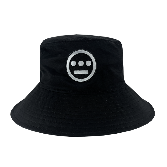 The Hiero Boonie Hat by Hieroglyphics is a black bucket hat crafted from recycled nylon, showcasing a striking white circular logo on the front. The logo features a solid circle with three smaller, evenly spaced circles inside it and three horizontal bars beneath them. This hat is designed with a wide, downward-sloping brim and visible stitching along the edges.