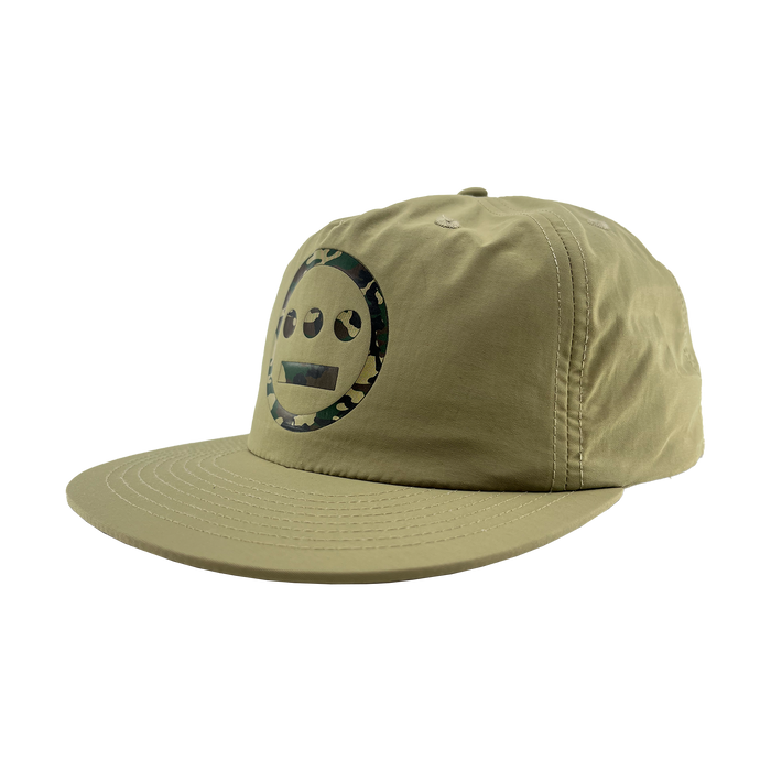 The Other Hiero Classic Camo Logo Hat is a khaki green snapback with flat brim, featuring a black Hieroglyphics smiley face logo in a camo circle, soft unstructured crown, and visible stitching—ideal for hip-hop style.
