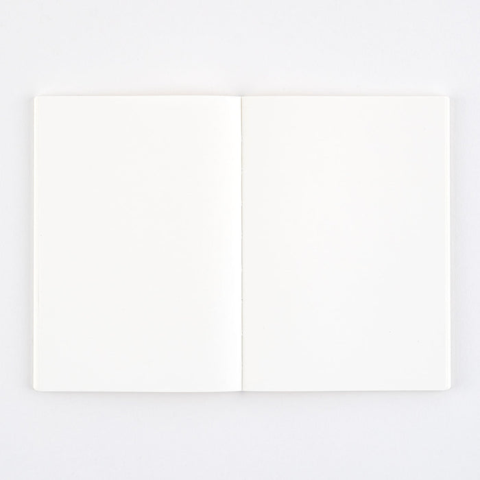 Notebook open with blank pages on light background