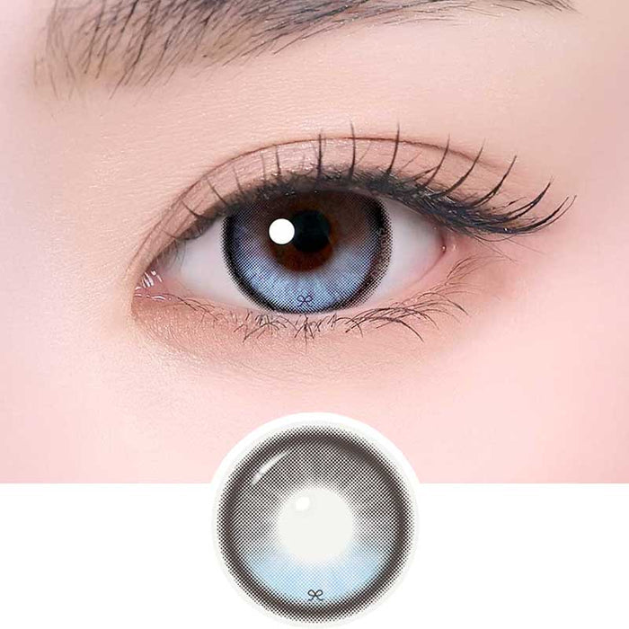 i-Sha Reborn Reborn Sky Veil color contact lens on top of a dark eye paired with subtle eye makeup and curled wispy eyelashes, above the contact lens design.
