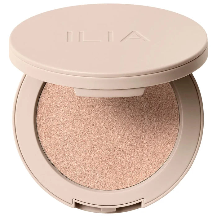 Ilia Lightshift Weightless Silky Cream Highlighter with a shimmering glow, shown in a sleek compact with a reflective finish.