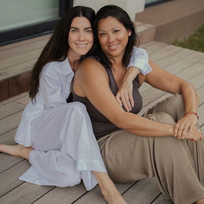 two women sitting on a porch