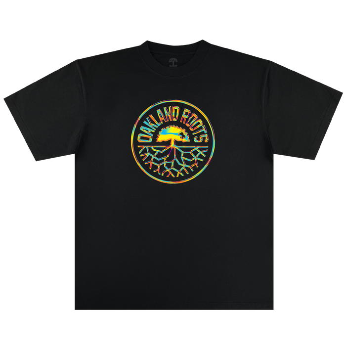 The Iridescent Tee by Oakland Roots SC features a vibrant circular logo with a yellow, green, and red tree design—celebrating the club's spirit and community roots.