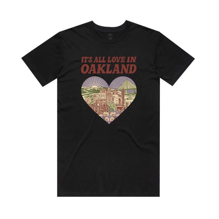 Oaklandish’s “It’s All Love in Oakland Tee” features red text and a heart graphic with city landmarks—buildings, hills, flowers, the port, and Bay Bridge—celebrating The Town’s spirit in soft colors.
